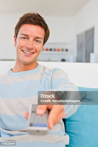 Happy Young Man Holding Remote Control Stock Photo - Download Image Now - 20-24 Years, 20-29 Years, Adult