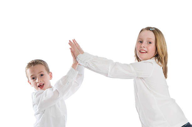 boy and girl double high five stock photo