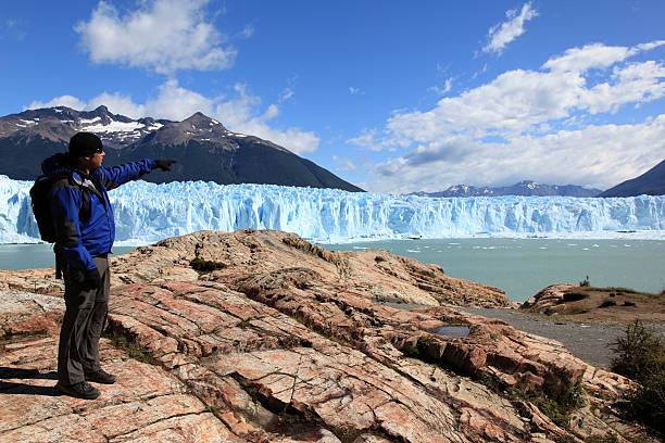 istock Man Hiker with Baclpack Pointing the Perito Moreno Glacier 173625813
