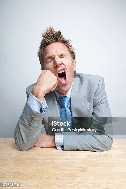 Bored Tired Businessman Office Worker Yawning At His Desk Stock Photo - Download Image Now
