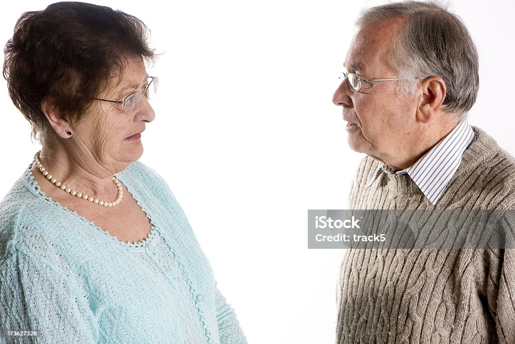 seniors: concerned conversation "A worried conversation between an elderly couple.Character study, studio shot on a white background." 70-79 Years Stock Photo