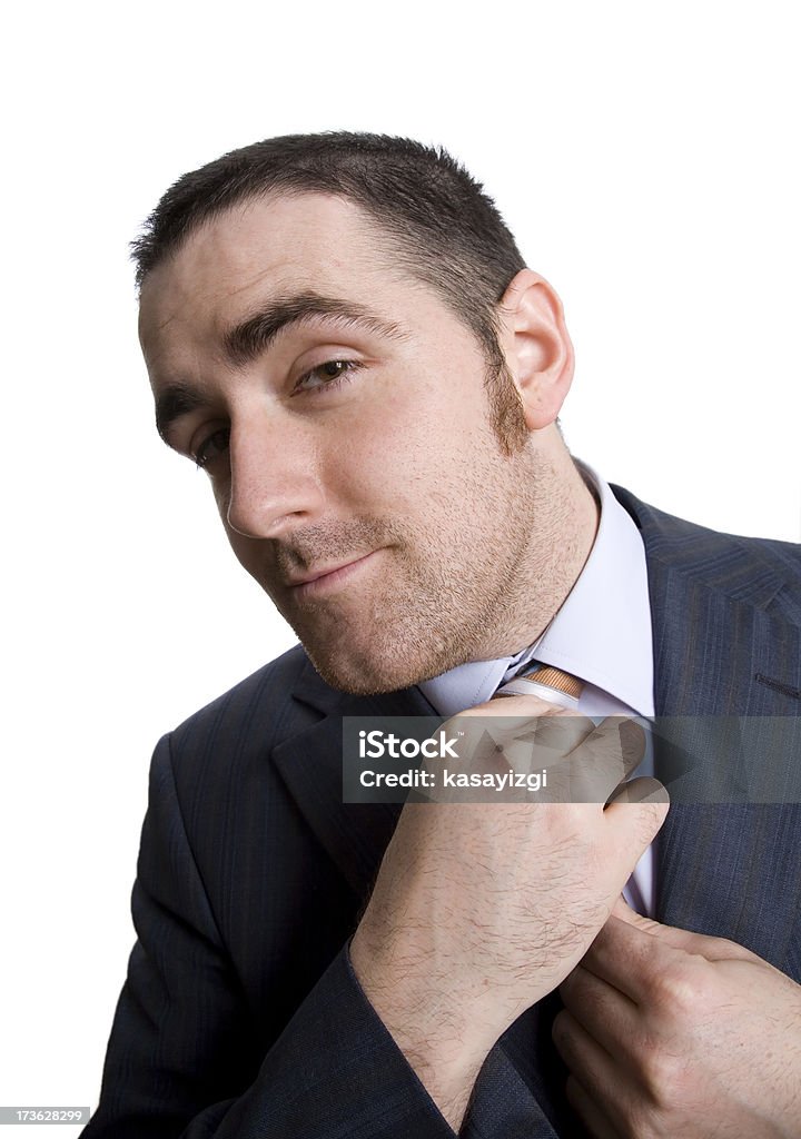 Business man checking his tie isolated Tying necktie isolated on white Adult Stock Photo