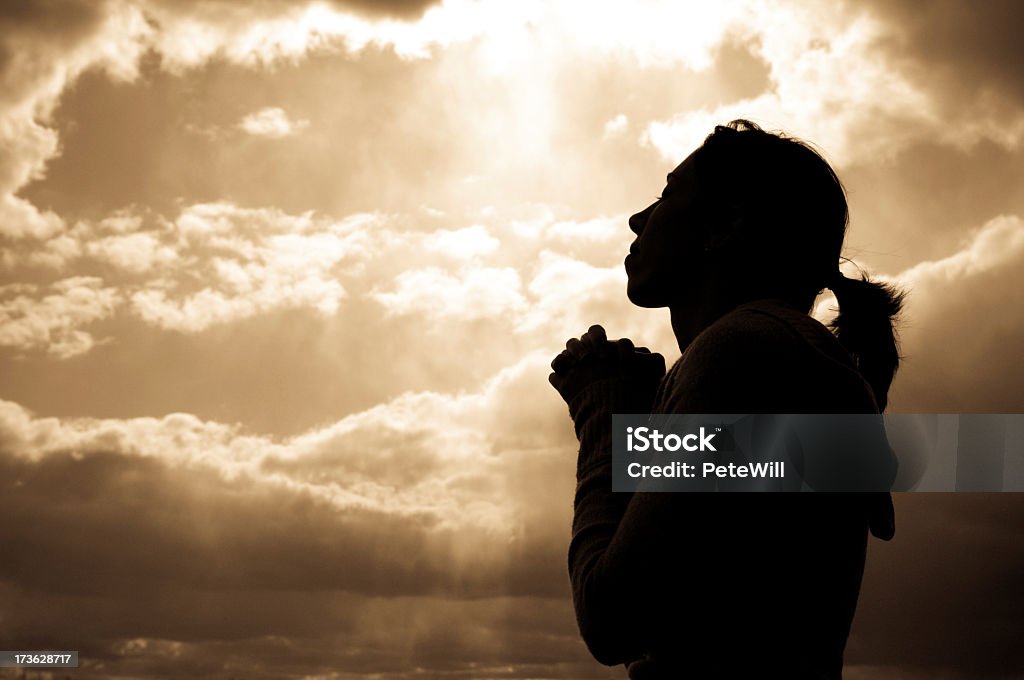 Silhouette of a woman looking at the sky, praying A women praying.Similar Images: Praying Stock Photo