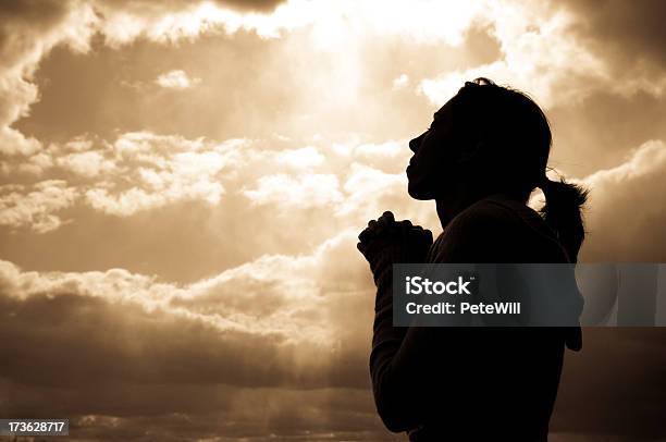 Silhouette Of A Woman Looking At The Sky Praying Stock Photo - Download Image Now - Praying, Women, One Woman Only