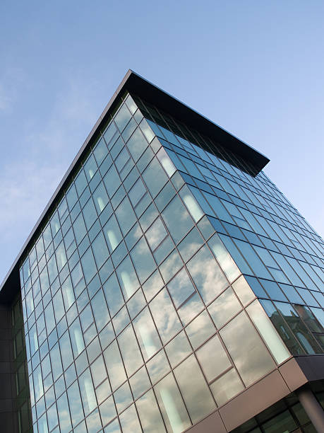 istock Reflected sky and clouds in glass office building 173628940