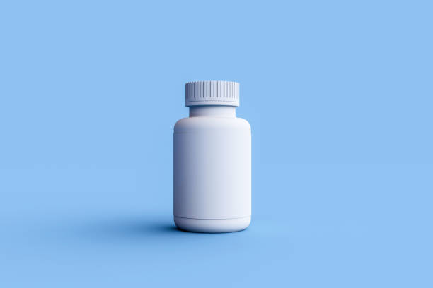 istock White pills bottle on blue background with copy space. 1736291254