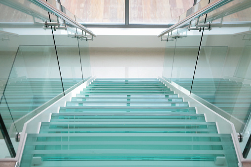 Modern glass stairs in plush new apartment. high key light and airy feel. 