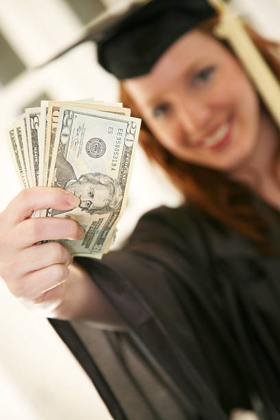 istock Young Woman Graduation Gift Money 173631293