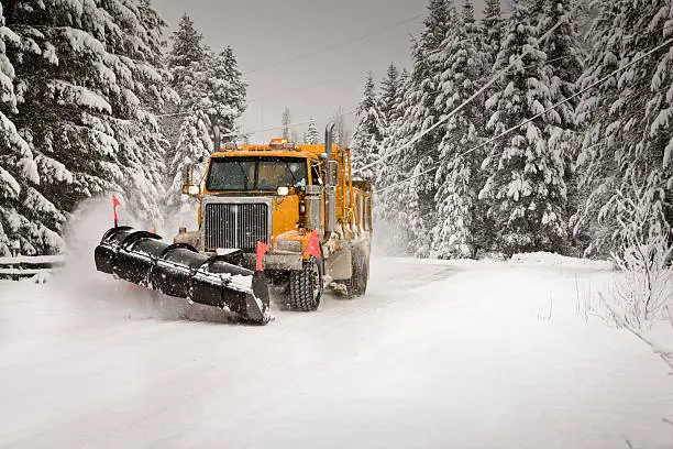 Snowplow clearing snow in a winter storm.