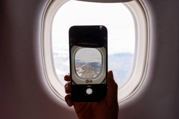 istock View of the camera phone throw the plane window 1736330000