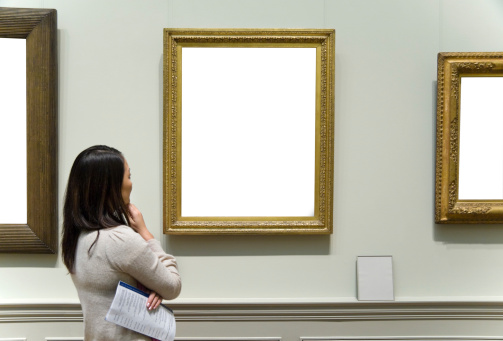Young Asian woman viewing art at a museum. Artwork  has been Removed for you to fill with your artwork.  Program is illegible.Please Also See: