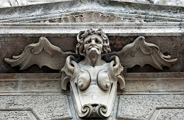 istock Statue of an old, ugly woman on a wall 173635279