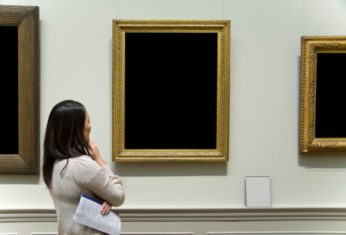 Young woman viewing art in a museum. Artwork  has been Blacked-out for you to fill with your artwork.  Program is Blurred and illegible.Please Also See: