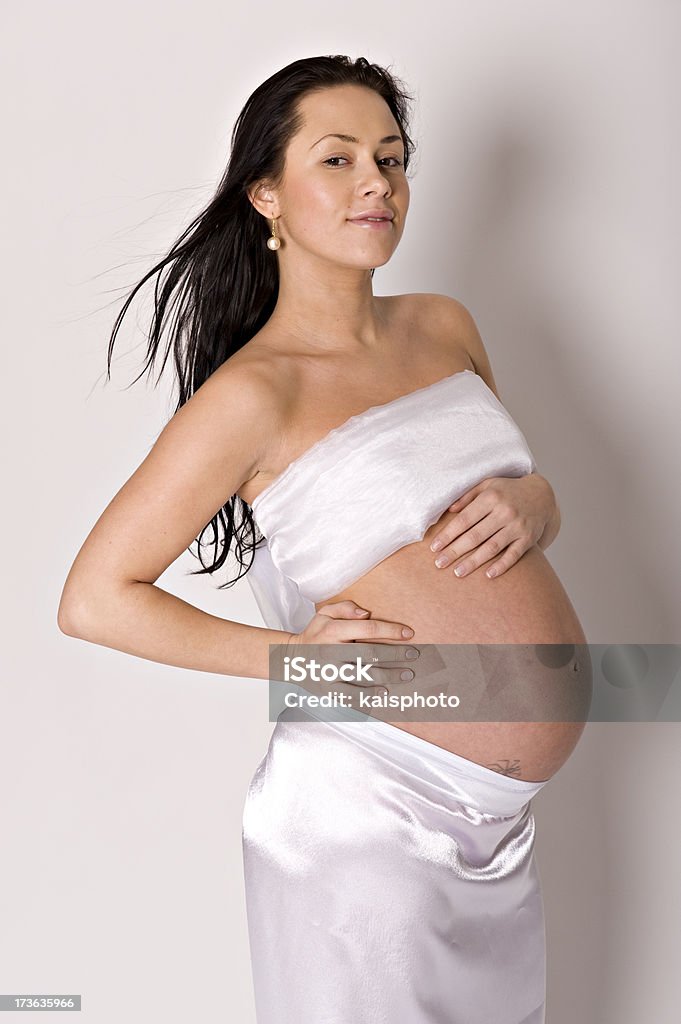 Pregnant girl Pregnant girl over grey background. 20-29 Years Stock Photo