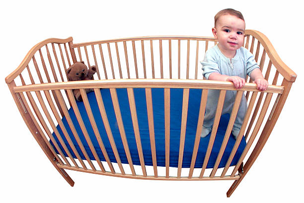 Baby stands in his crib. Shot with Nikon Coolpix 4500 and fisheye attachment. Silo/white bkgd/clipping path.View my other photos of