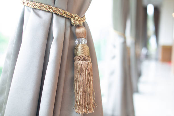 istock Curtains with curtain fasteners on gray windows 1736360213