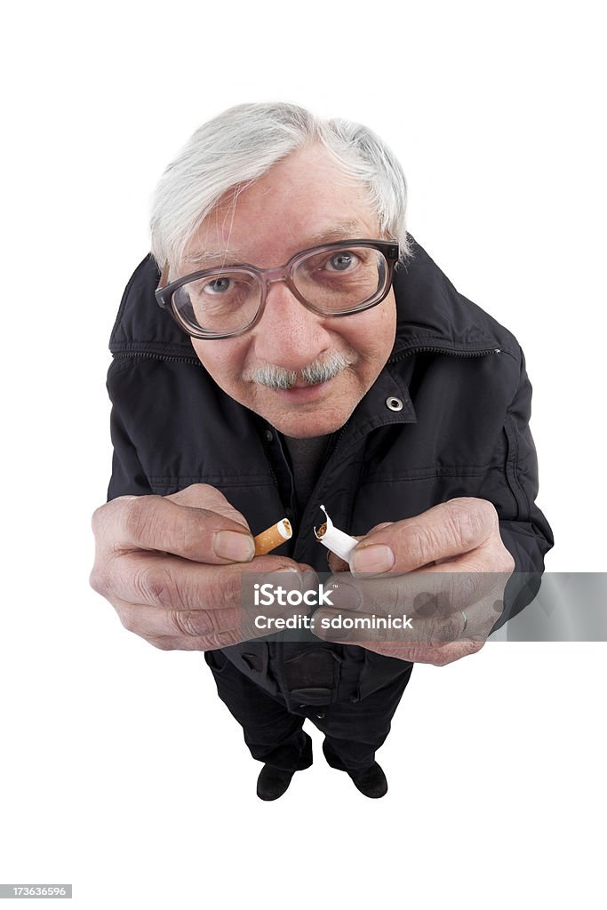 Finally Quitting A fisheye image of a senior man breaking a cigarette. Cigarette Stock Photo