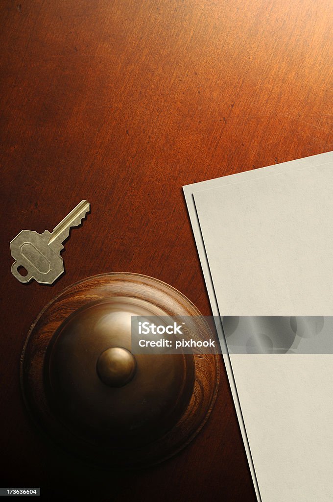 Reception Desk "Service Bell, Room Key, and Blank Paper on Desk Top." High Angle View Stock Photo