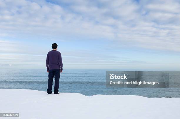 Young Man Looking Out To Sea Stock Photo - Download Image Now - Adult, Adults Only, Blue