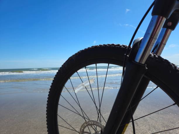 Close Up Of Bicycle Front Wheel On The Sandy Beach