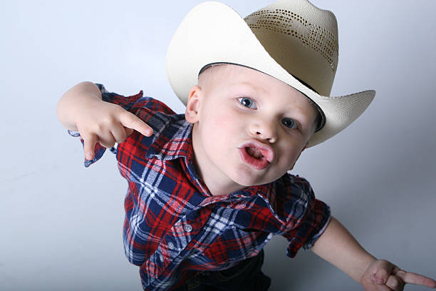 young cowboy rocking out stock photo