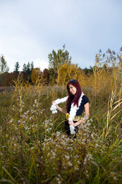 A woman outdoors in long grass.