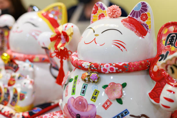 istock Cute Maneki neko cat waving with paw close up 1736394161