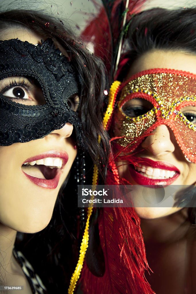 Carnival fiesta "confetti falling on two  young girls with masks (XXXL, Canon 5D mark II)" 20-24 Years Stock Photo