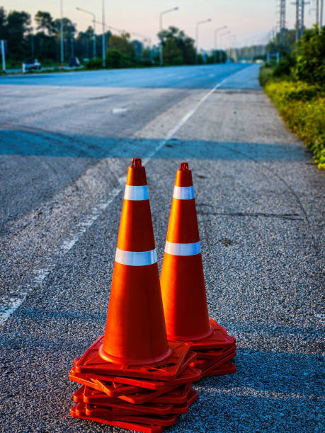 istock Stacked traffic cones are placed along the roadside ready for use. 1736400509