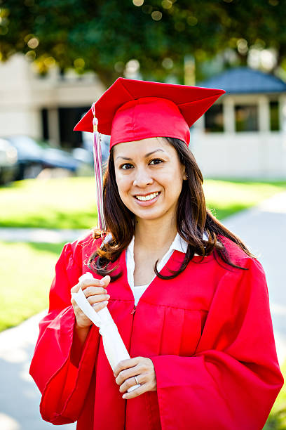 istock pretty graduate with diploma portrait 173640469