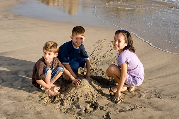 istock Happy kids by the beach 173640587