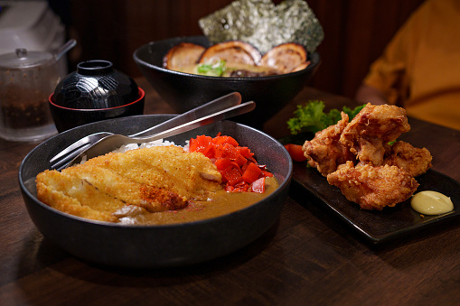Pork cutlet curry and rice, chicken Karaage, and tonkatsu ramen, representing traditional Japanese cuisine