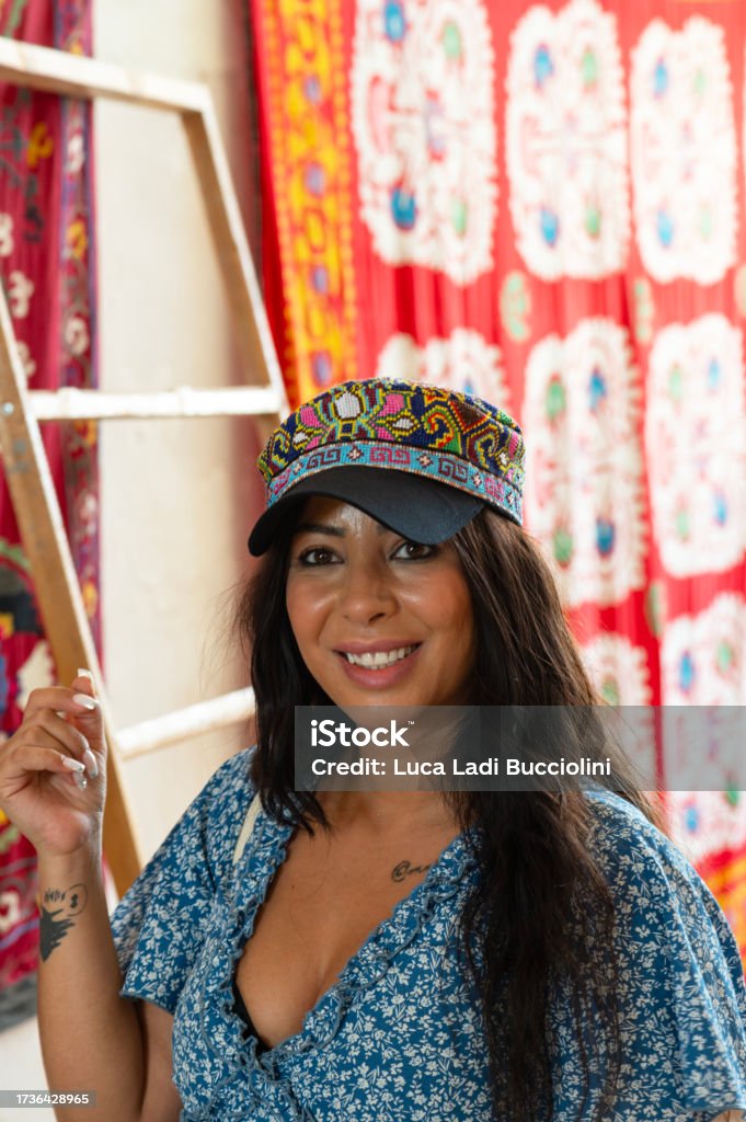 Lady close up next to traditional carpets in Shahrisabz, Uzbekistan Lady close up standing next to traditional carpets in Shahrisabz, Uzbekistan Adult Stock Photo