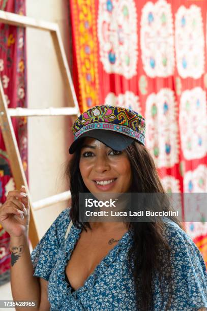 Lady Close Up Next To Traditional Carpets In Shahrisabz Uzbekistan Stock Photo - Download Image Now