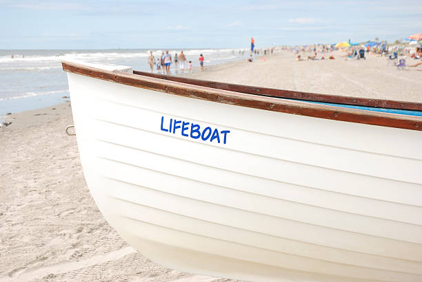 istock Lifeboat on crowd beach in summer 173643582