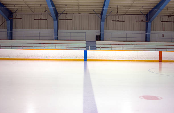 A blue and red line on an ice rink View of blue line of an empty ice hockey rink. ice rink stock pictures, royalty-free photos & images