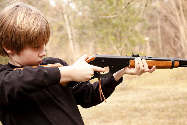 istock Young boy learning safety and  to shoot his BB gun 173643758