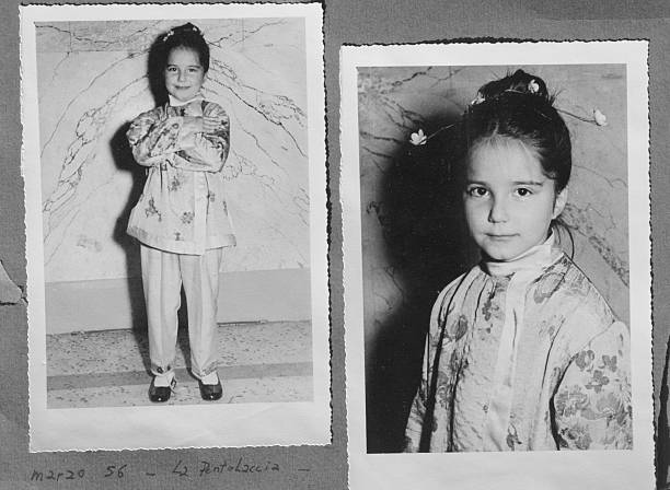 Black and white photo from 1956 Little girl with japanese costume.Black and white photo album.Some scratches and noise. sequence dress stock pictures, royalty-free photos & images