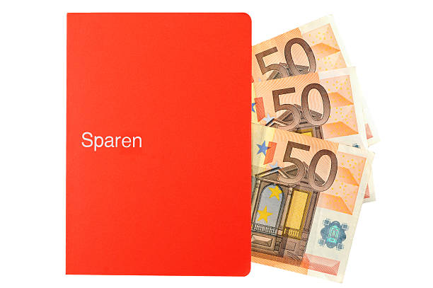 paper currency falling in savings bank book. 3 x 50 Euro. German words sparen (saving money). Sparen isnt a company name. Finance and business background.