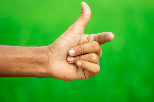 A human hand and green background