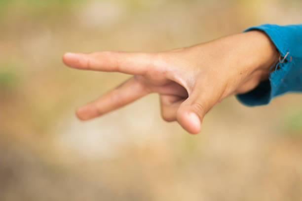istock A human hand show two finer and green background 1736511055