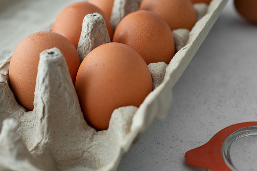 A closeup view of a carton of large brown eggs.