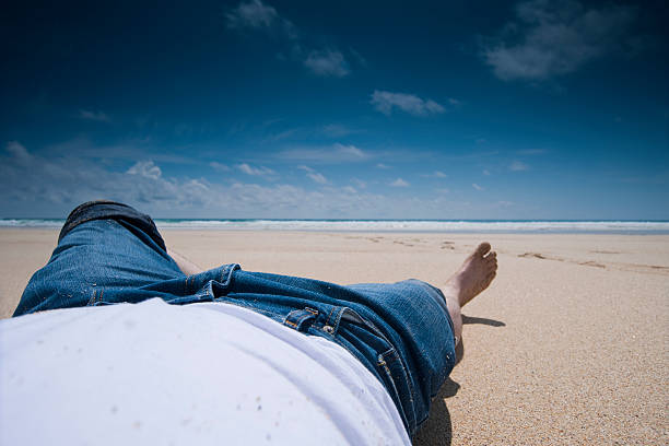 istock perfect day, man lying on a beautiful beach 173652438