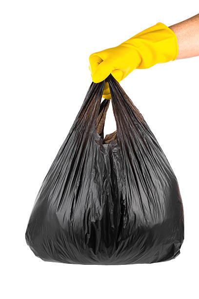istock glove holding Garbage and trash bag isolated on white background 173652743