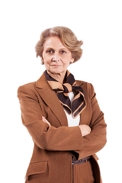 Attractive senior woman dressed in brown pants suit stock photo