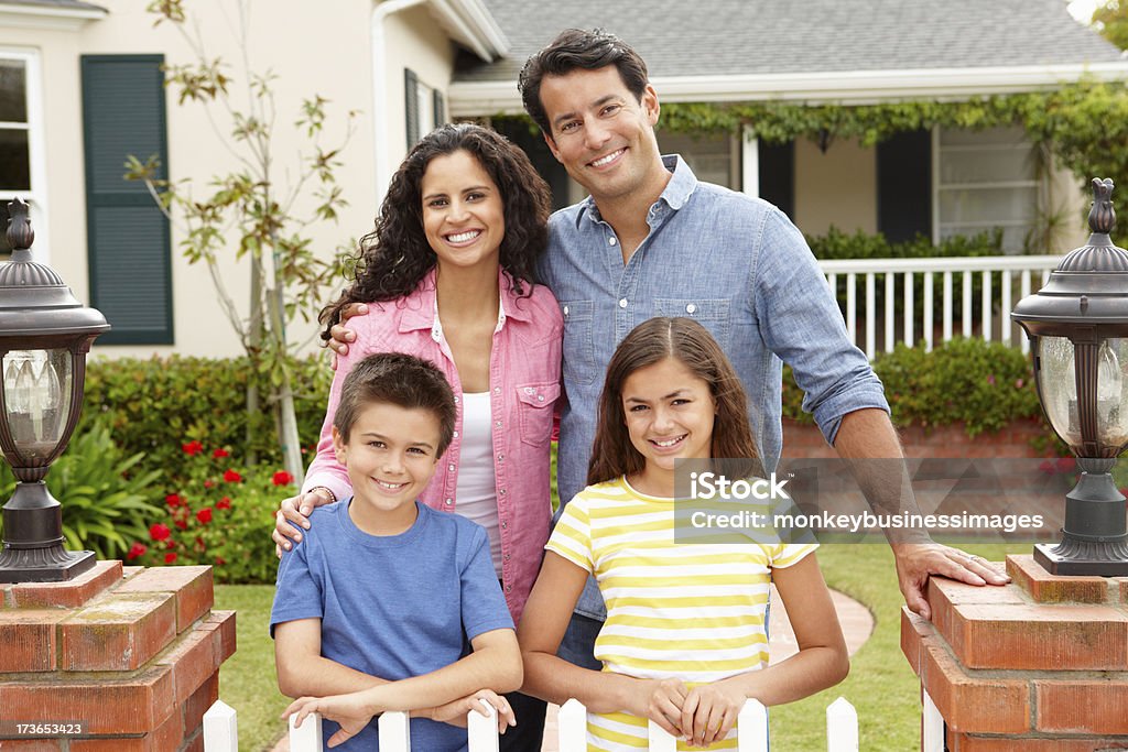 Hispanic family outside home Hispanic family outside home smiling at camera Family Stock Photo