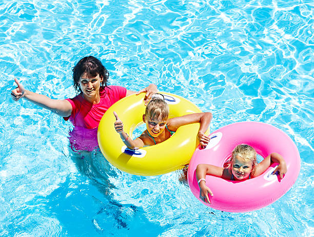 istock Family in swimming pool. 173655312