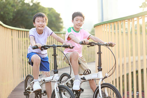 The boy on the bike in the park.