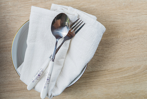High Angle View of Silver Cutlery Set in Linen Napkin