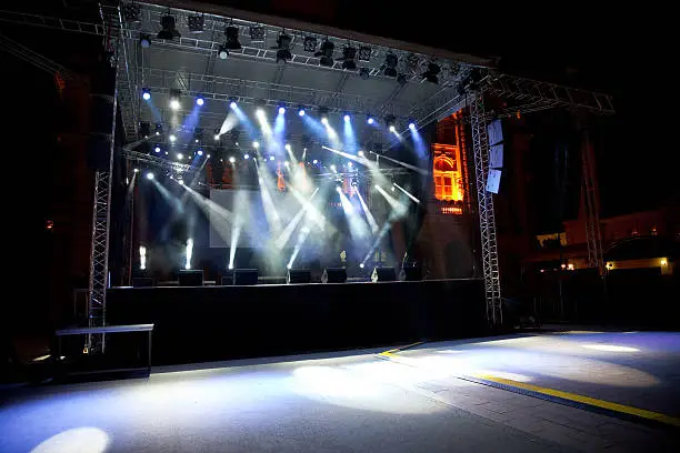 empty stage and screen in the rays of light concert